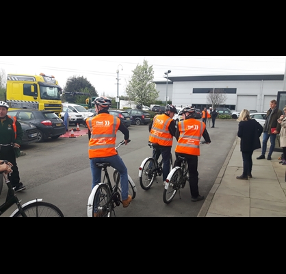 People in high-vis jackets cycling