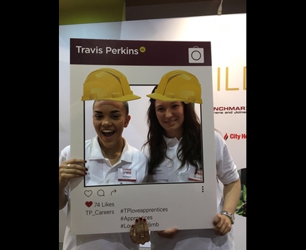 Two people holding a Travis Perkins instagram filter